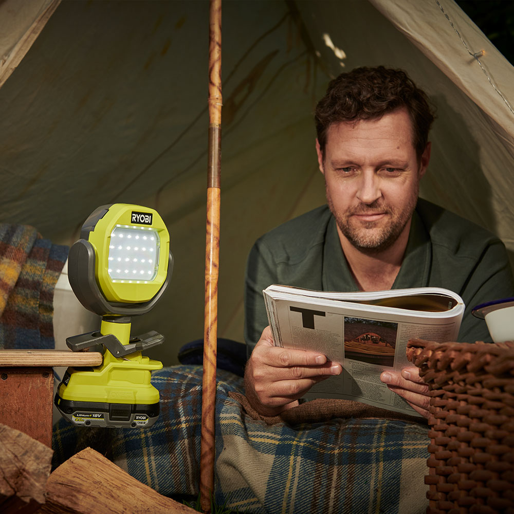 Man reading in a tent